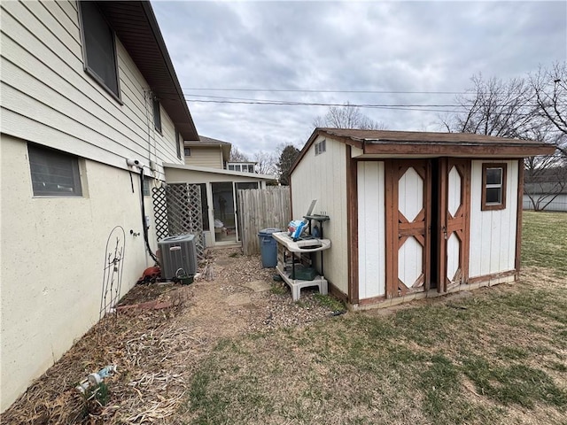 view of shed featuring central AC unit, fence, and a sunroom