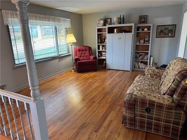 sitting room with baseboards and wood finished floors