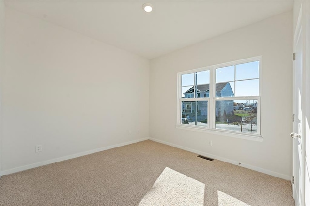 carpeted empty room featuring visible vents, recessed lighting, and baseboards