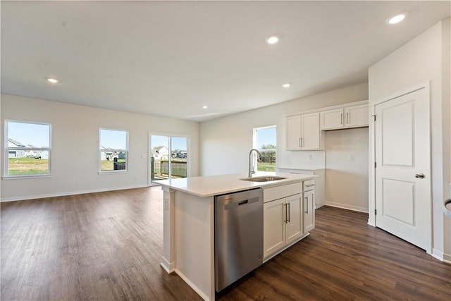 kitchen featuring a sink, dishwasher, white cabinets, and dark wood-type flooring