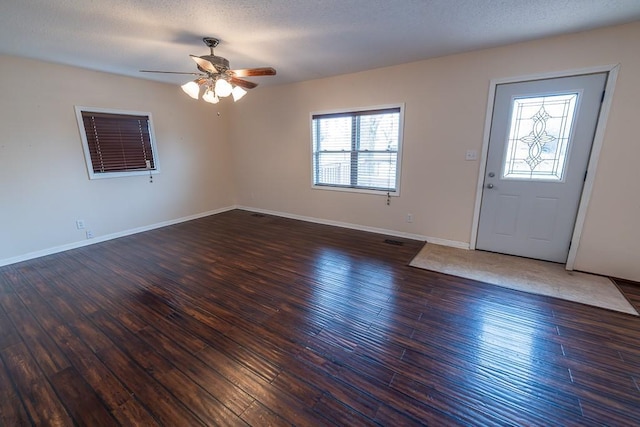 entryway featuring baseboards, a textured ceiling, a ceiling fan, and hardwood / wood-style flooring