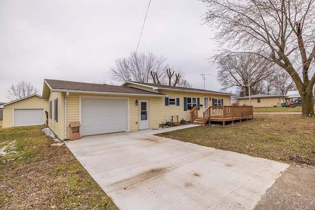 view of front of house featuring a deck, concrete driveway, and a garage