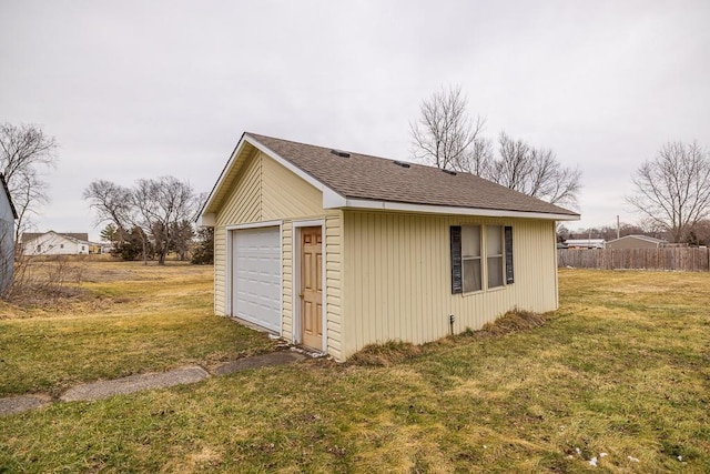 detached garage featuring fence