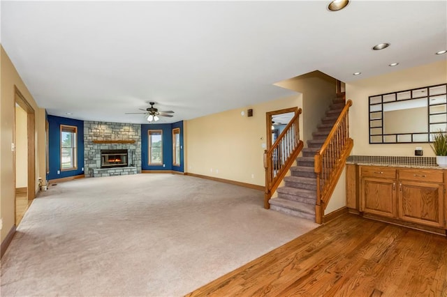 1796 NW 770th Rd, Bates City, MO 64011 - unfurnished living room featuring baseboards, a ceiling fan, a fireplace, stairway, and recessed lighting