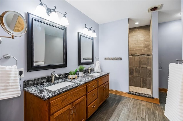 1796 NW 770th Rd, Bates City, MO 64011 - bathroom with wood finished floors, baseboards, double vanity, and a tile shower