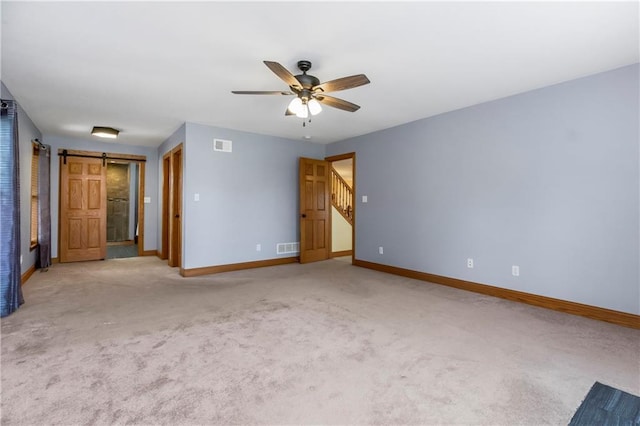 1796 NW 770th Rd, Bates City, MO 64011 - spare room with baseboards, ceiling fan, light carpet, and a barn door