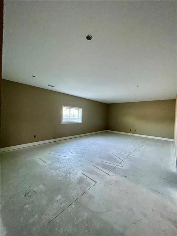 1302 NE 122nd St, Kansas City, MO 64165 - empty room with concrete floors and baseboards