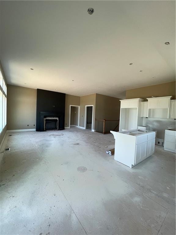 1302 NE 122nd St, Kansas City, MO 64165 - unfurnished living room with baseboards and a fireplace
