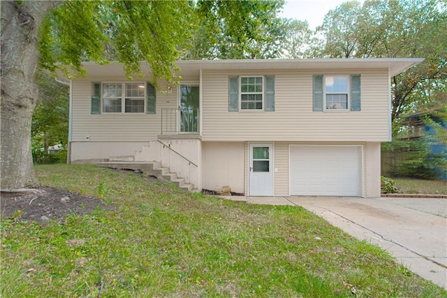 view of front facade with stairway, driveway, an attached garage, and a front yard