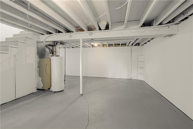 unfinished basement featuring gas water heater