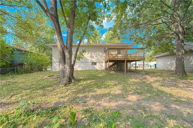 rear view of house with fence, a wooden deck, stairs, a lawn, and crawl space