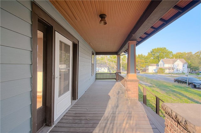 wooden deck featuring a residential view and covered porch