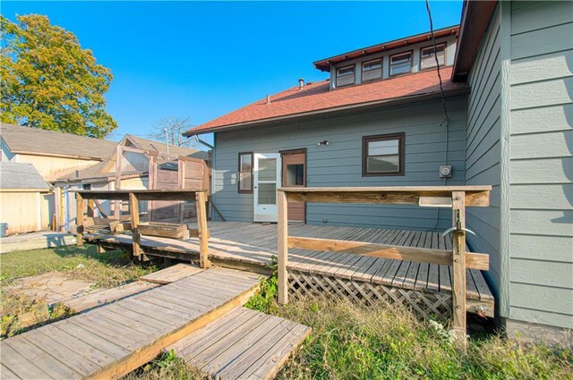 back of property featuring a wooden deck