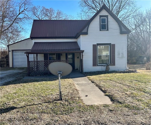 view of front of house with covered porch, metal roof, and a front yard