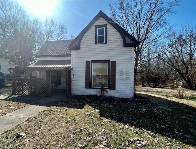 view of front facade with covered porch and metal roof