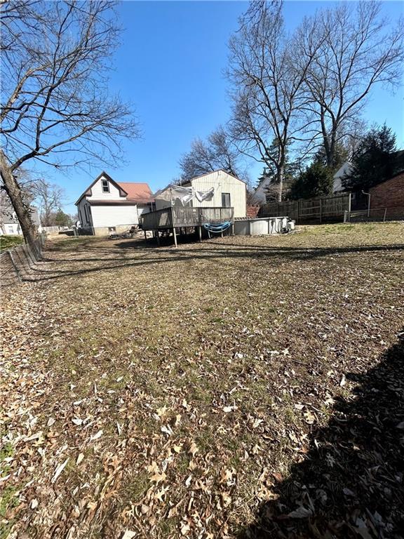 view of yard featuring a deck and fence