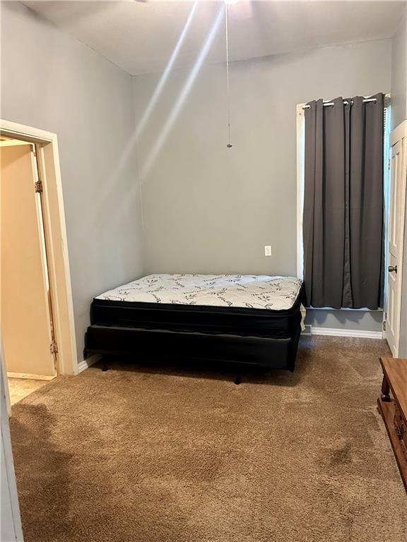 carpeted bedroom with baseboards