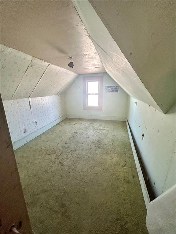 bonus room featuring baseboards, lofted ceiling, and carpet