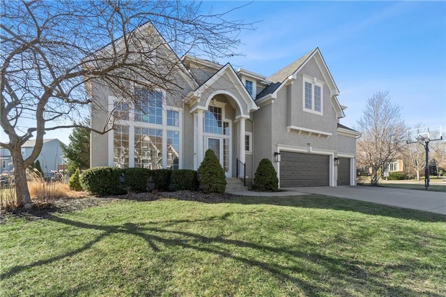 traditional-style house featuring stucco siding, a front lawn, concrete driveway, and an attached garage