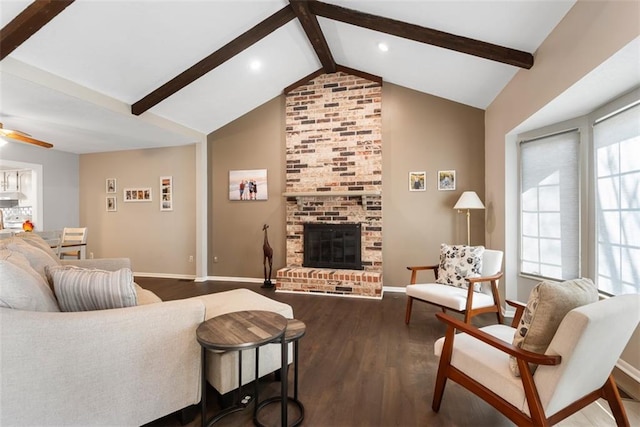 living area featuring dark wood-style floors, baseboards, vaulted ceiling with beams, a fireplace, and ceiling fan