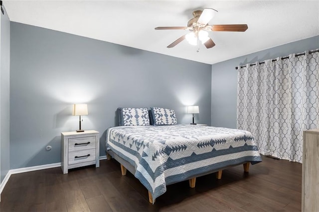 bedroom featuring baseboards, wood finished floors, and a ceiling fan