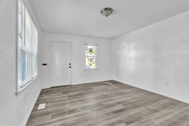 empty room featuring baseboards and wood finished floors