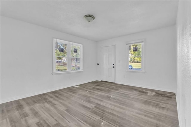 3309 E 69th St, Kansas City, MO 64132 - unfurnished room with baseboards and wood finished floors