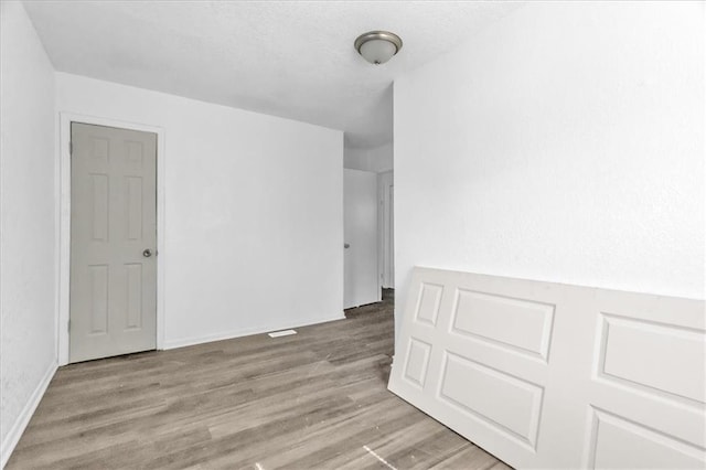 3309 E 69th St, Kansas City, MO 64132 - empty room with a textured ceiling and wood finished floors