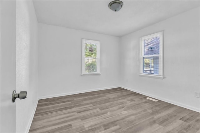 3309 E 69th St, Kansas City, MO 64132 - spare room with baseboards and wood finished floors