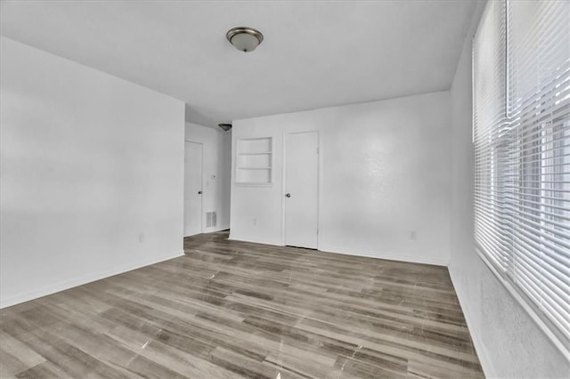 3309 E 69th St, Kansas City, MO 64132 - spare room with wood finished floors and baseboards