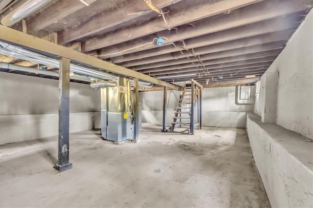 3309 E 69th St, Kansas City, MO 64132 - unfinished below grade area featuring heating unit and stairs