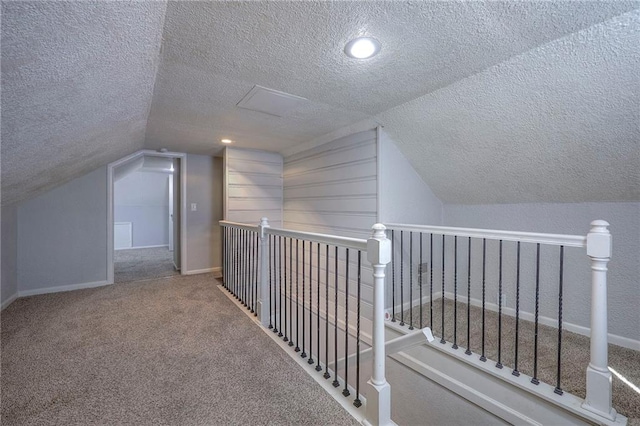 bonus room featuring vaulted ceiling, baseboards, carpet floors, and a textured ceiling