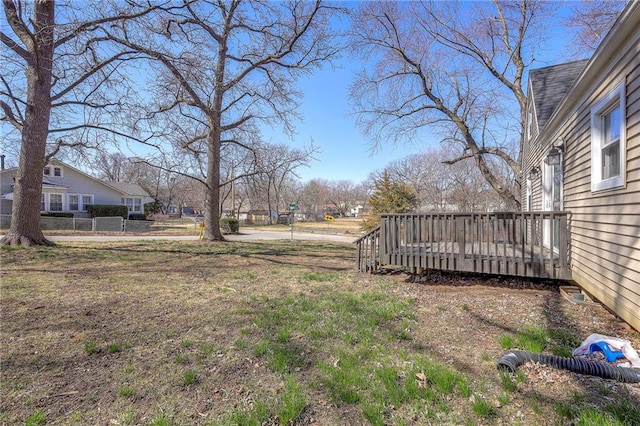 view of yard with a wooden deck and fence