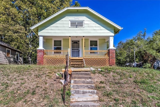 view of front of home with a porch and stairs