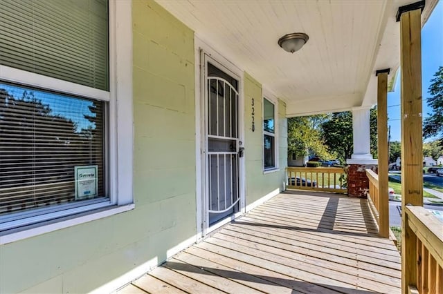 wooden terrace featuring covered porch