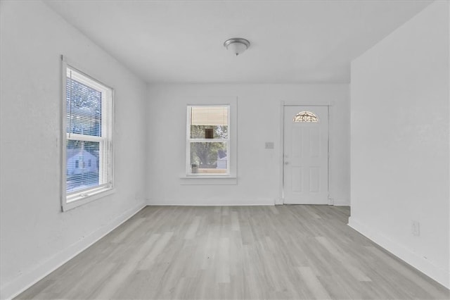 interior space featuring plenty of natural light, light wood-style floors, and baseboards