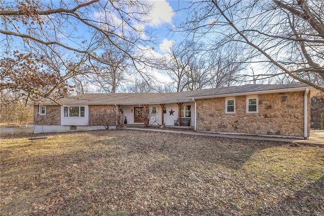 single story home with covered porch and stone siding