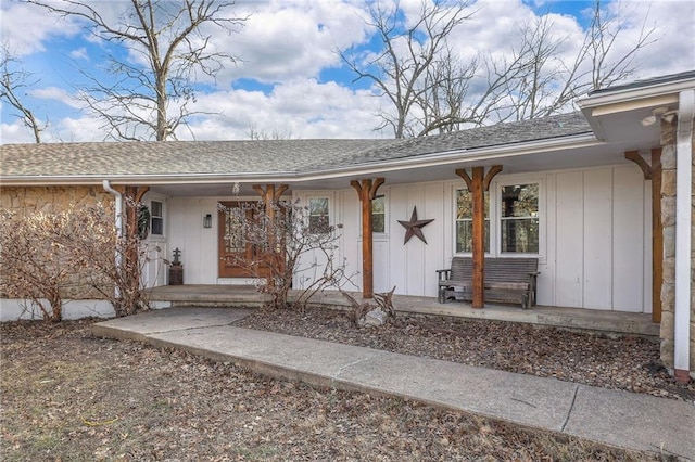 entrance to property featuring a porch, board and batten siding, and a shingled roof