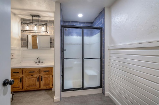 bathroom featuring vanity, tile patterned floors, and a stall shower