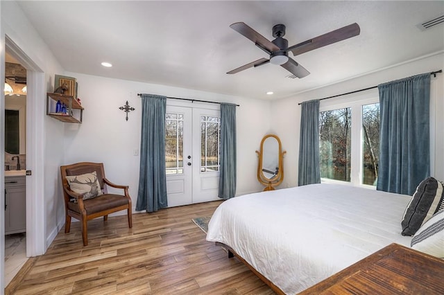 bedroom featuring visible vents, access to outside, recessed lighting, french doors, and light wood finished floors