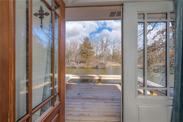 doorway to outside with visible vents and a water view