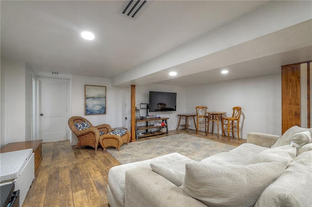 living area featuring recessed lighting, wood finished floors, and visible vents