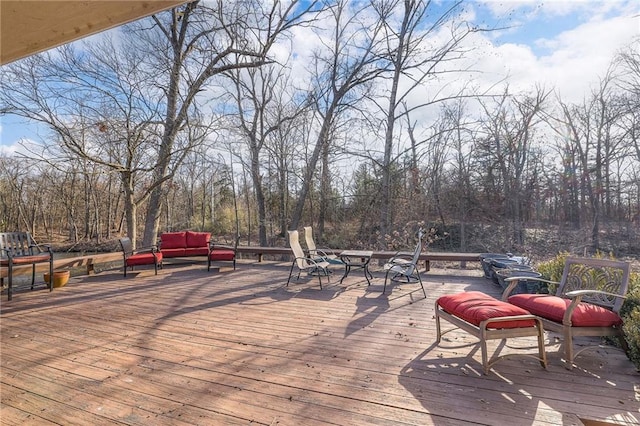 wooden deck with an outdoor living space