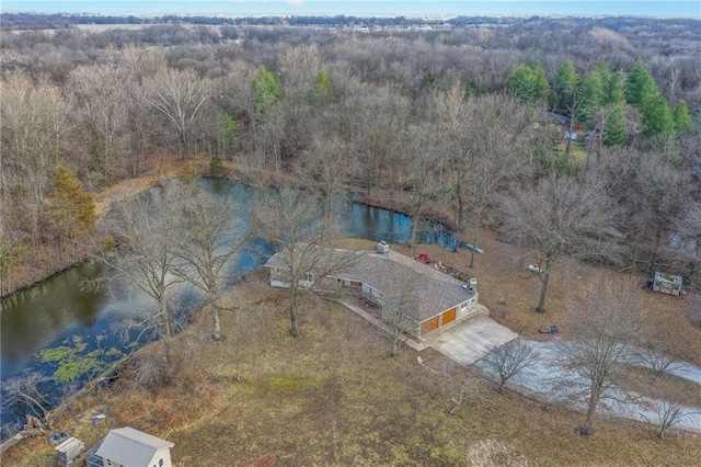 drone / aerial view featuring a water view and a wooded view