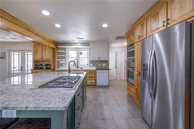 350 NW 71p Rd, Clinton, MO 64735 - kitchen featuring a healthy amount of sunlight, recessed lighting, light stone counters, a sink, and appliances with stainless steel finishes
