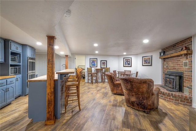 350 NW 71p Rd, Clinton, MO 64735 - living room featuring bar area, recessed lighting, and wood finished floors
