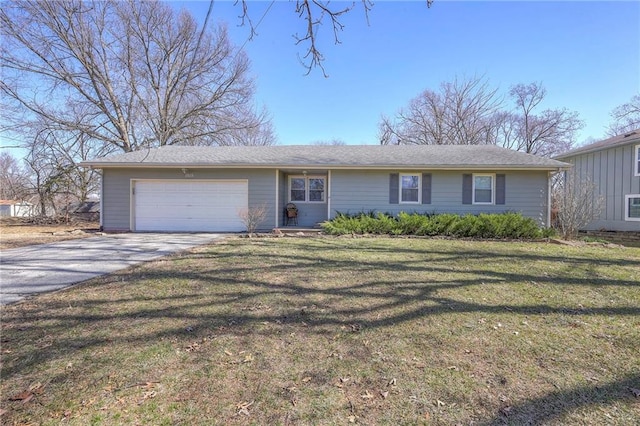 view of front facade with a front yard, an attached garage, and driveway