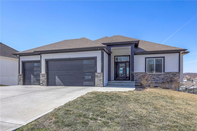 prairie-style house featuring stucco siding, driveway, stone siding, a front yard, and a garage