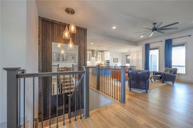 stairway featuring a ceiling fan, recessed lighting, and wood finished floors