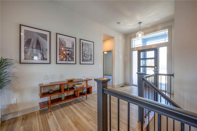 interior space with baseboards and light wood-type flooring